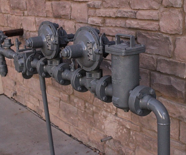 Copper water supply pipes connected to a wall