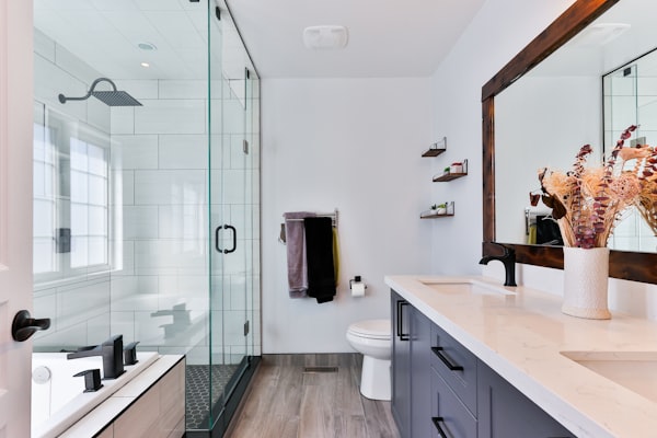 Modern renovated bathroom with white sink and mirror